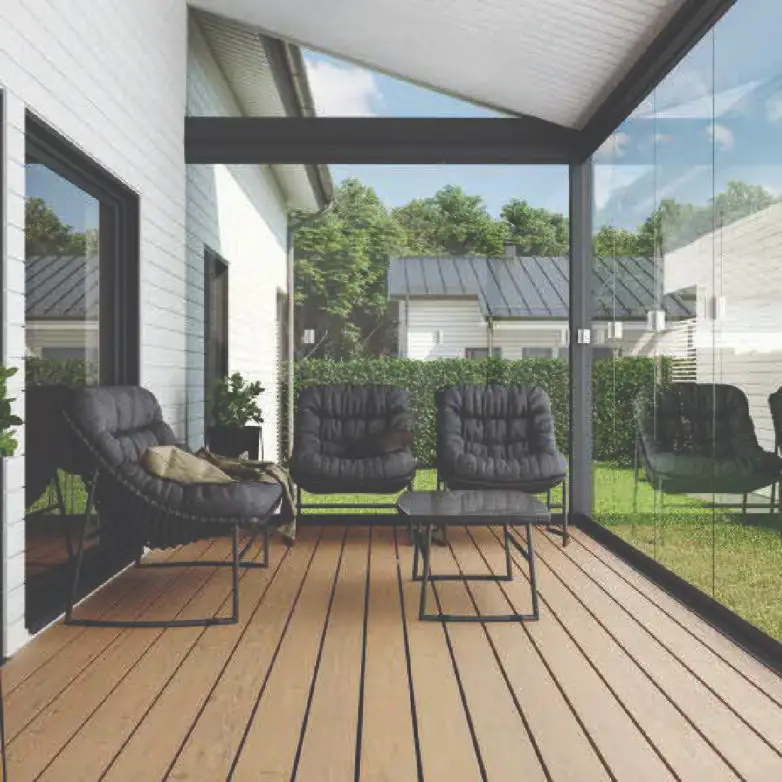 Covered patio enclosure with wood deck and glass walls, furnished with black cushioned chairs and modern outdoor seating.